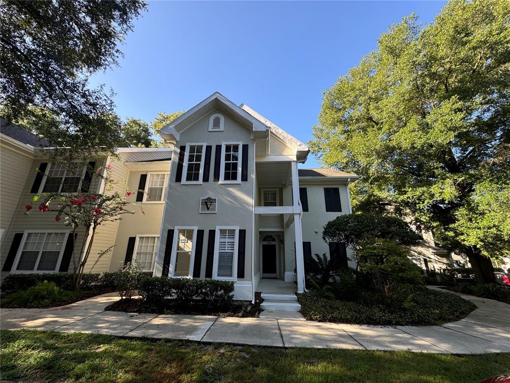 10000 Southwest 52nd Avenue, Unit 139 Gainesville, FL 32608 - Photo 1 of 16 a front view of a house with a yard