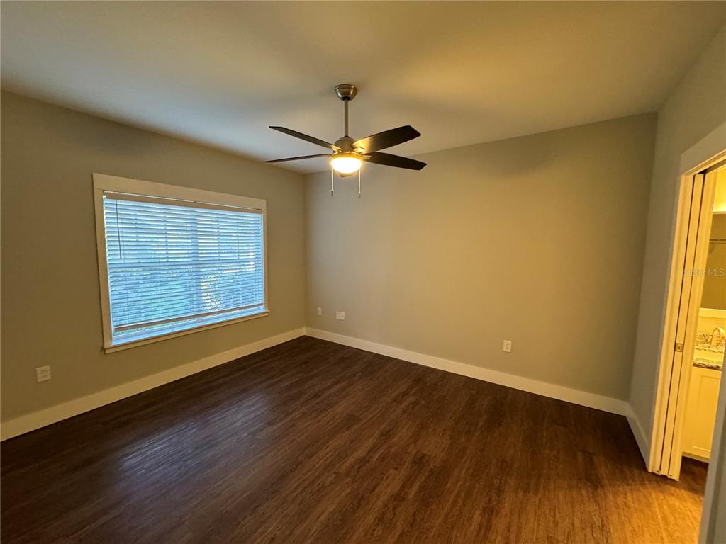 10000 Southwest 52nd Avenue, Unit 139 Gainesville, FL 32608 - Photo 13 of 16 a view of an empty room with wooden floor and a window