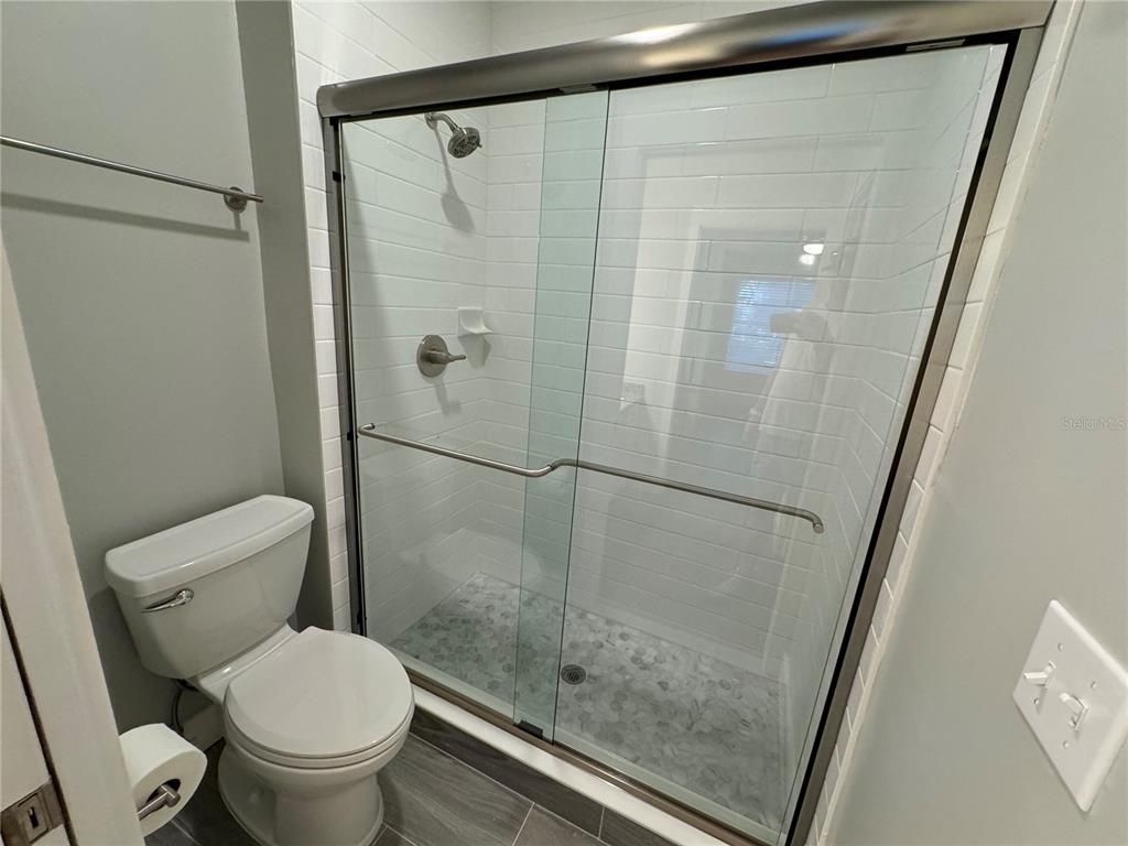 10000 Southwest 52nd Avenue, Unit 139 Gainesville, FL 32608 - Photo 15 of 16 a white toilet sitting next to a bathroom sink