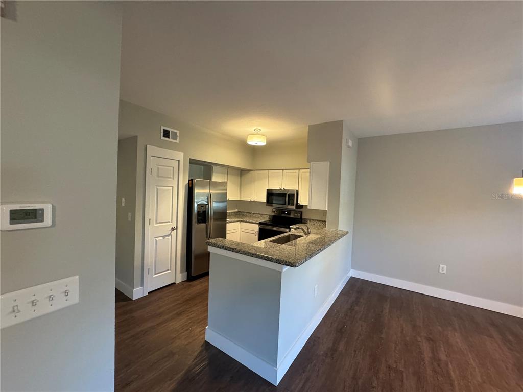 10000 Southwest 52nd Avenue, Unit 139 Gainesville, FL 32608 - Photo 4 of 16 a kitchen with stainless steel appliances a sink and a refrigerator