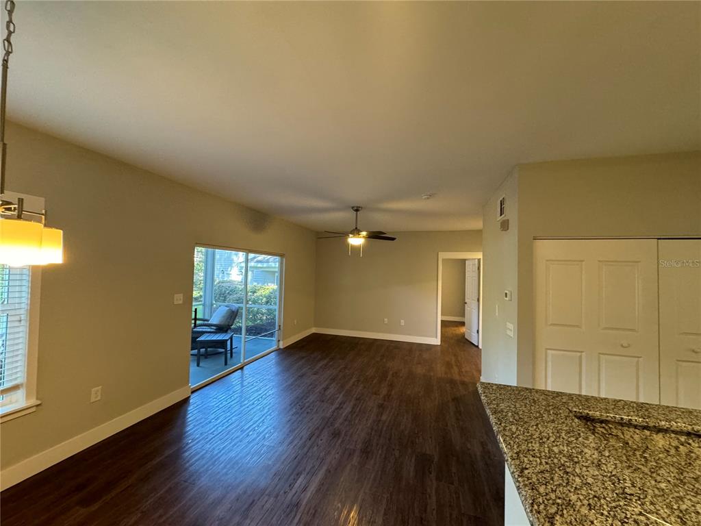 10000 Southwest 52nd Avenue, Unit 139 Gainesville, FL 32608 - Photo 7 of 16 an empty room with wooden floor and windows