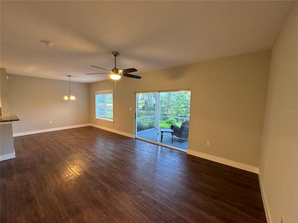 10000 Southwest 52nd Avenue, Unit 139 Gainesville, FL 32608 - Photo 9 of 16 a view of an empty room with wooden floor and a window