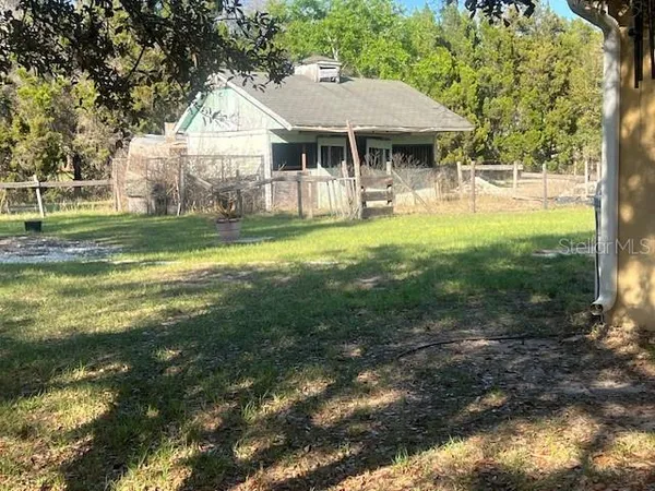 a view of a house with a yard balcony and sitting area