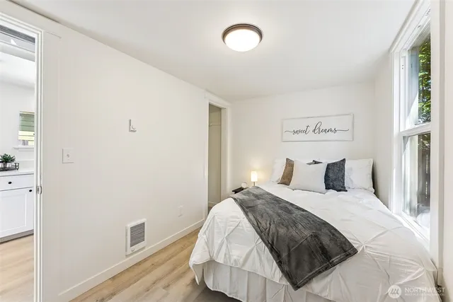 a bedroom with a bed and a window