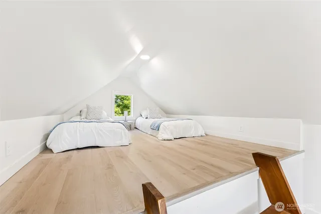 a bedroom with two beds and painted walls