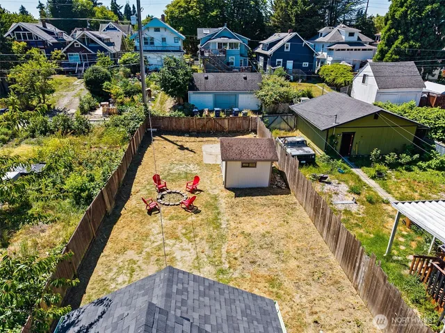 an aerial view of a house with a yard