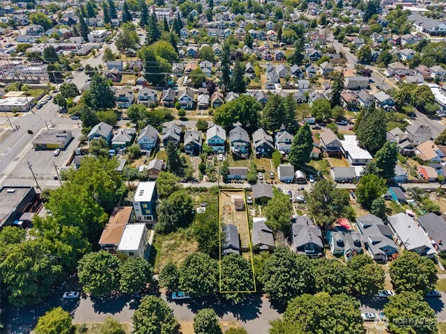 an aerial view of residential house with outdoor space and trees all around