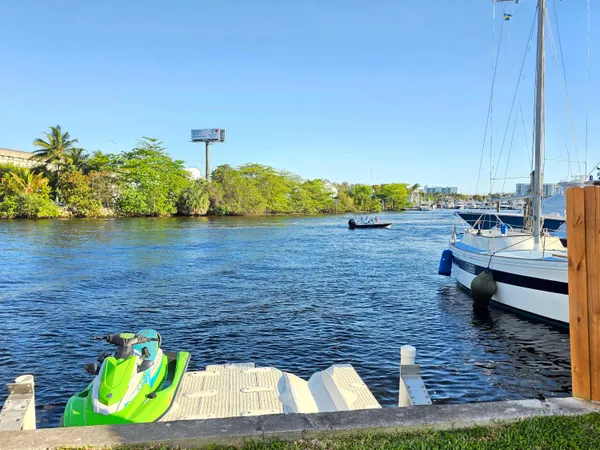 a view of a lake with couches chairs and a table