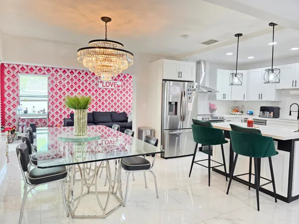 a view of kitchen island with furniture and chandelier