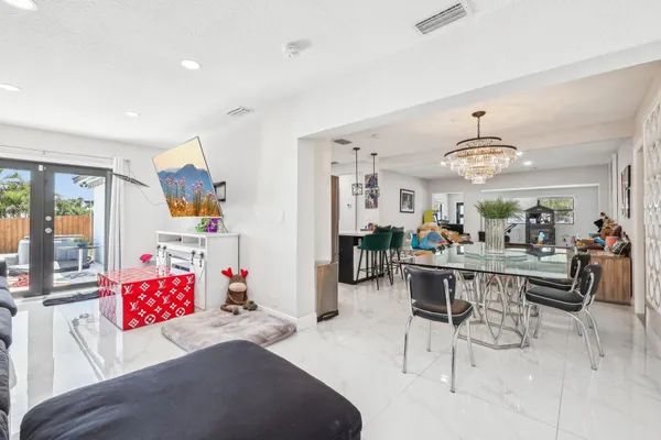 a living room with furniture and a chandelier