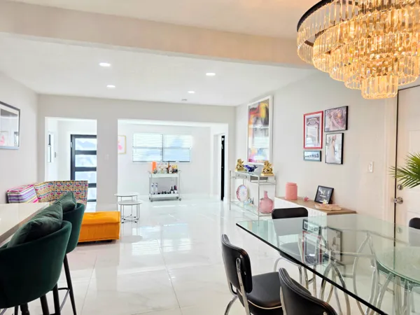 a living room with furniture and a chandelier