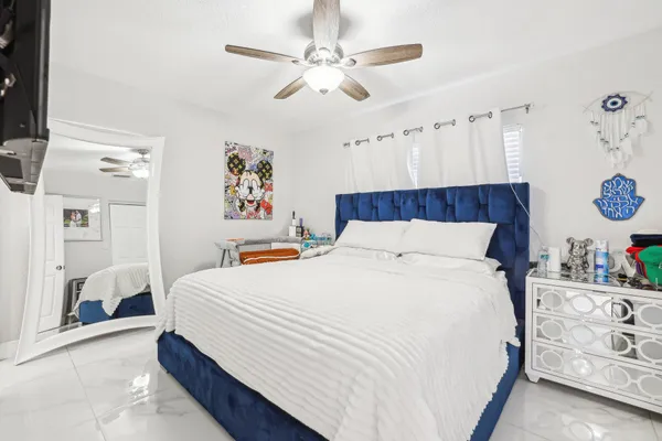 a bedroom with a bed and a window