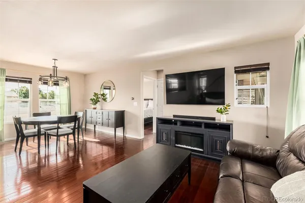 a living room with furniture a dining table with wooden floor