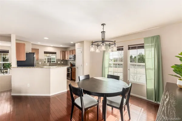 a view of kitchen with stainless steel appliances granite countertop refrigerator sink and microwave