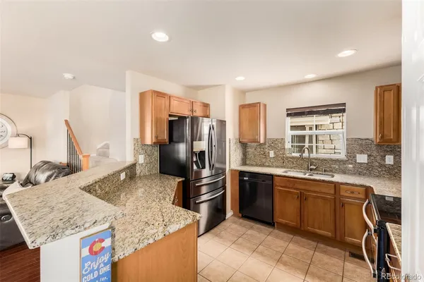 a kitchen with stainless steel appliances granite countertop a stove and a microwave