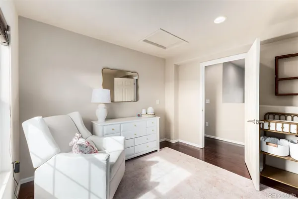 a spacious bedroom with a bed and a chandelier