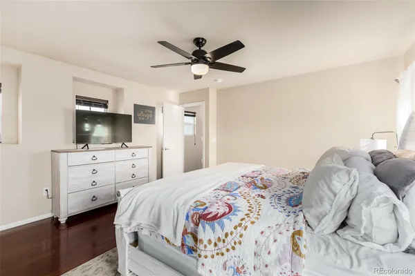 a bedroom with a bed and a ceiling fan