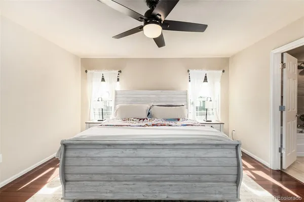 a bathroom with a bathtub shower sink mirror and toilet