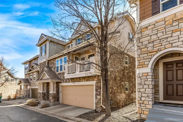 a view of a white house with large tree