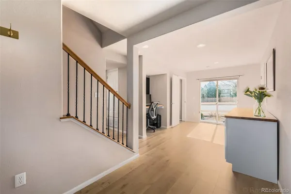 a view of a room with wooden floor and a potted plant