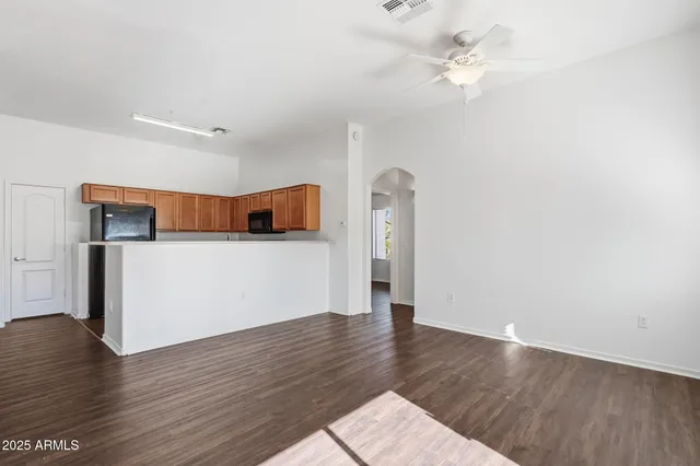 a view of a kitchen with wooden floor
