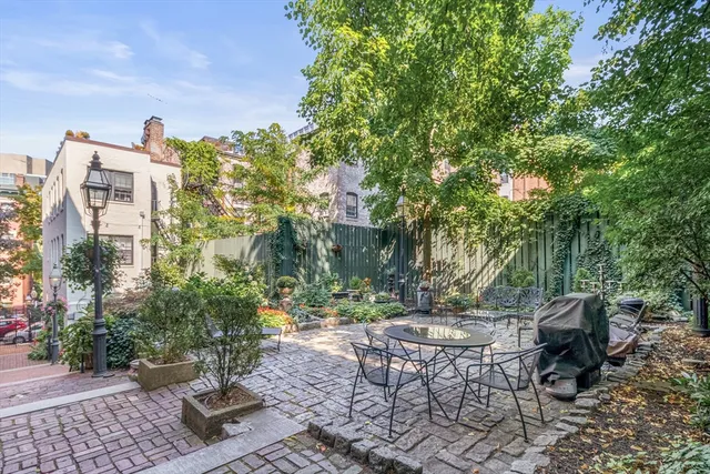 a view of a patio with table and chairs and potted plants