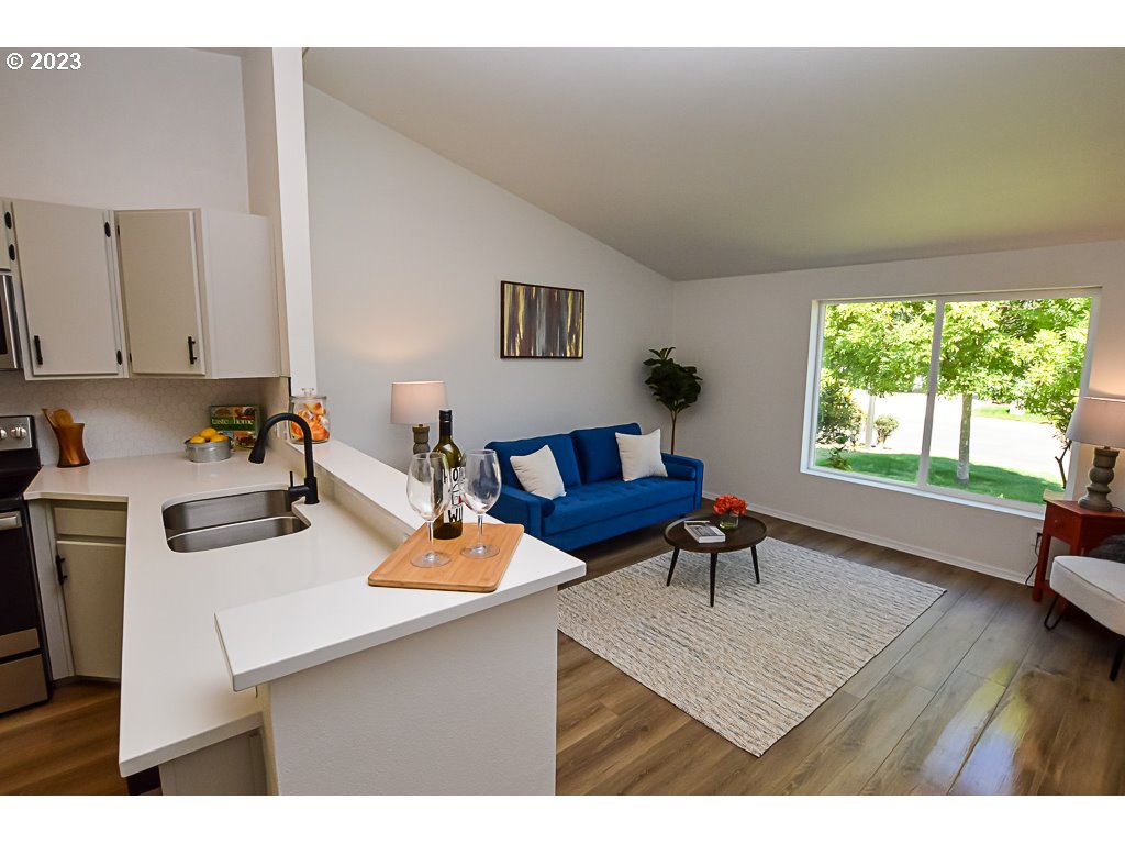 5332 Bridgewater Drive Eugene, OR 97402 - Photo 11 of 28 a living room with furniture and a wooden floor
