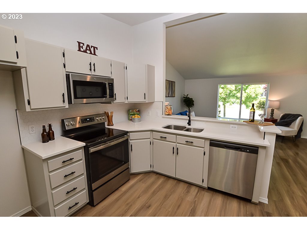 5332 Bridgewater Drive Eugene, OR 97402 - Photo 12 of 28 a kitchen with a sink stove and microwave