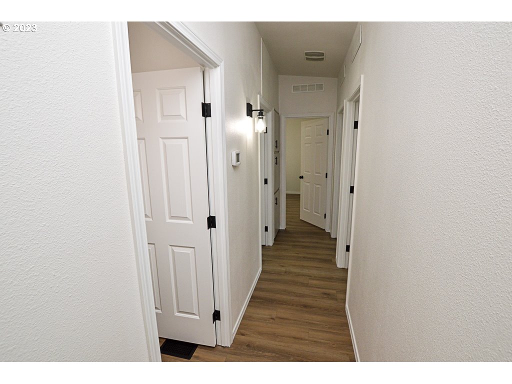 5332 Bridgewater Drive Eugene, OR 97402 - Photo 17 of 28 a view of a hallway with wooden floor