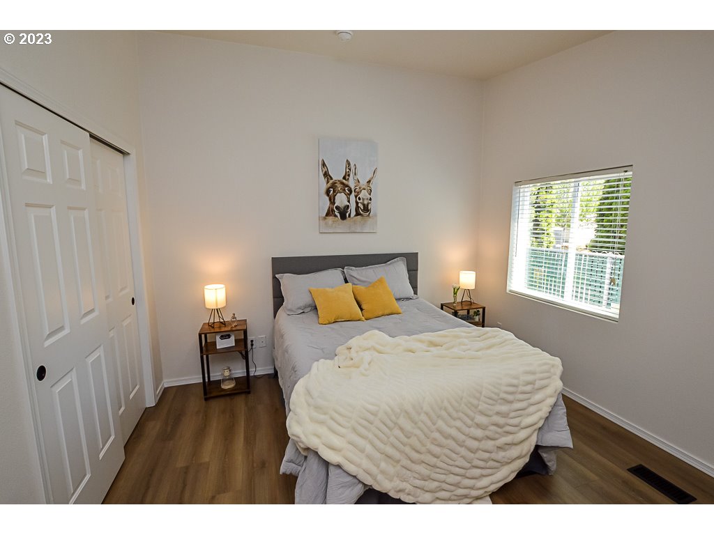 5332 Bridgewater Drive Eugene, OR 97402 - Photo 18 of 28 a bedroom with a bed and wooden floor