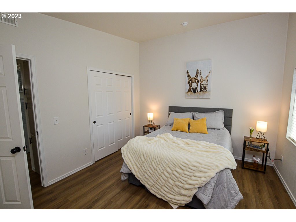 5332 Bridgewater Drive Eugene, OR 97402 - Photo 19 of 28 a bedroom with a bed and wooden floor