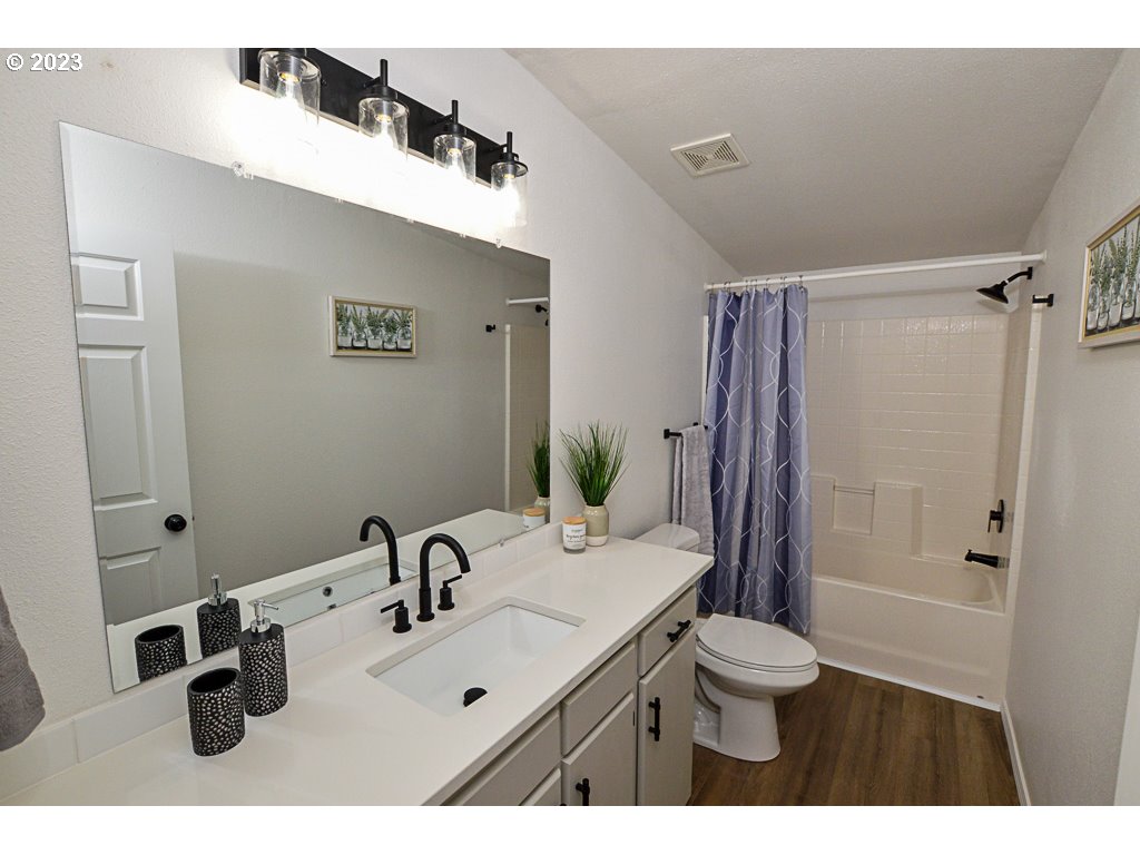 5332 Bridgewater Drive Eugene, OR 97402 - Photo 20 of 28 a bathroom with a sink mirror toilet and shower