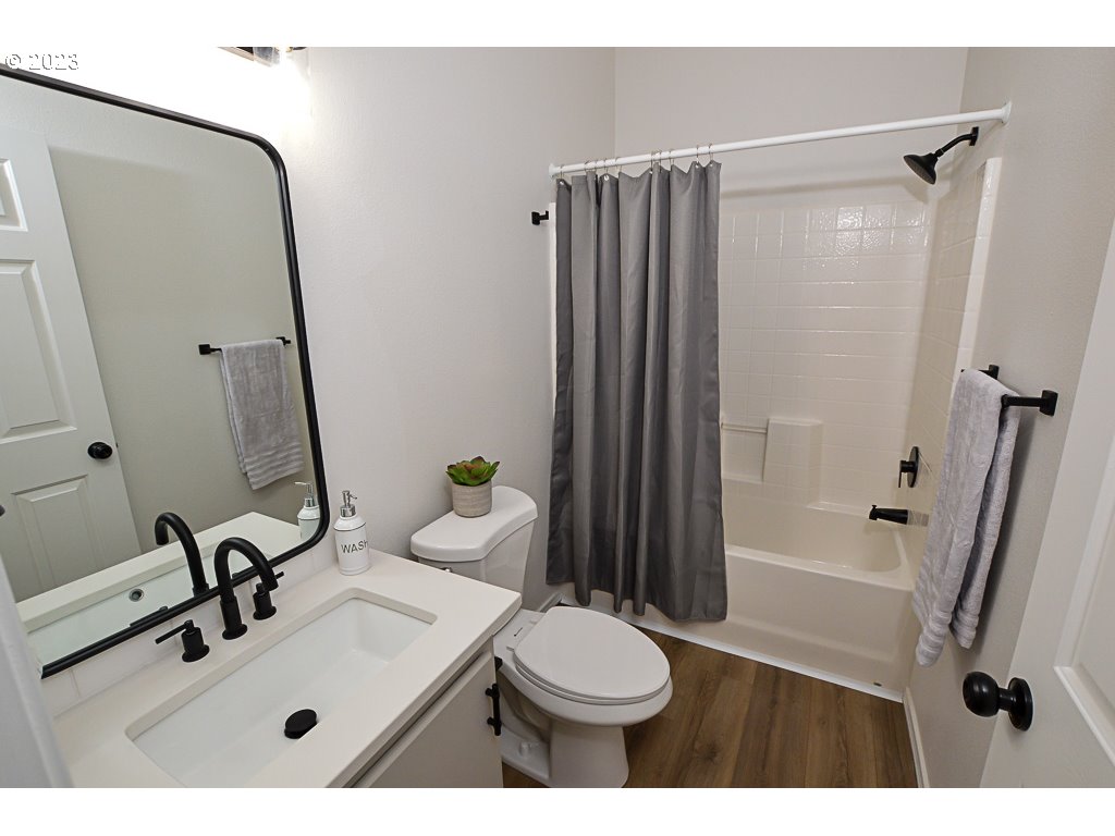 5332 Bridgewater Drive Eugene, OR 97402 - Photo 23 of 28 a bathroom with a sink a toilet and a mirror