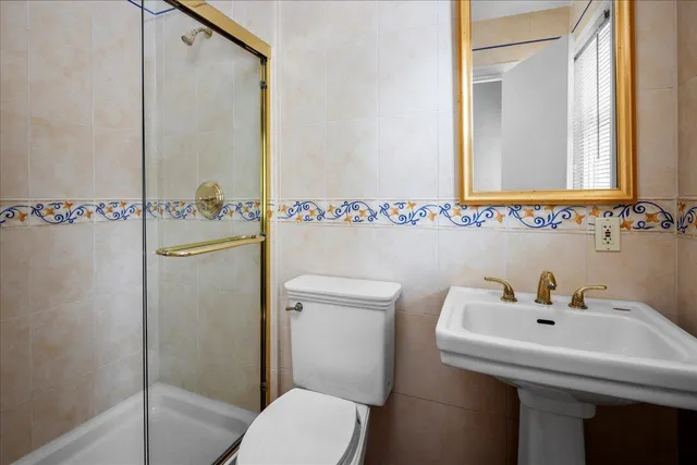 a bathroom with a sink mirror and toilet