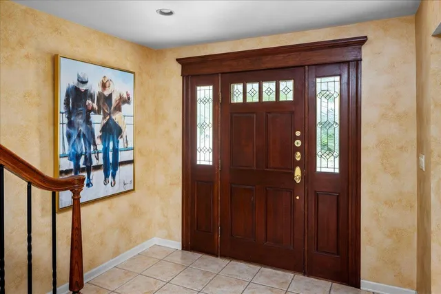 a view of a hallway with wooden floor and entryway