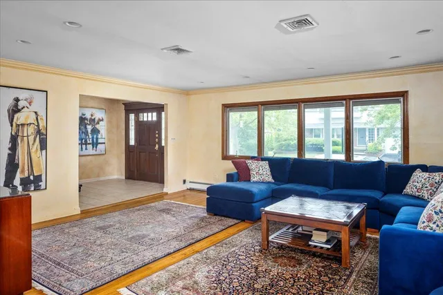 a living room with furniture rug and window