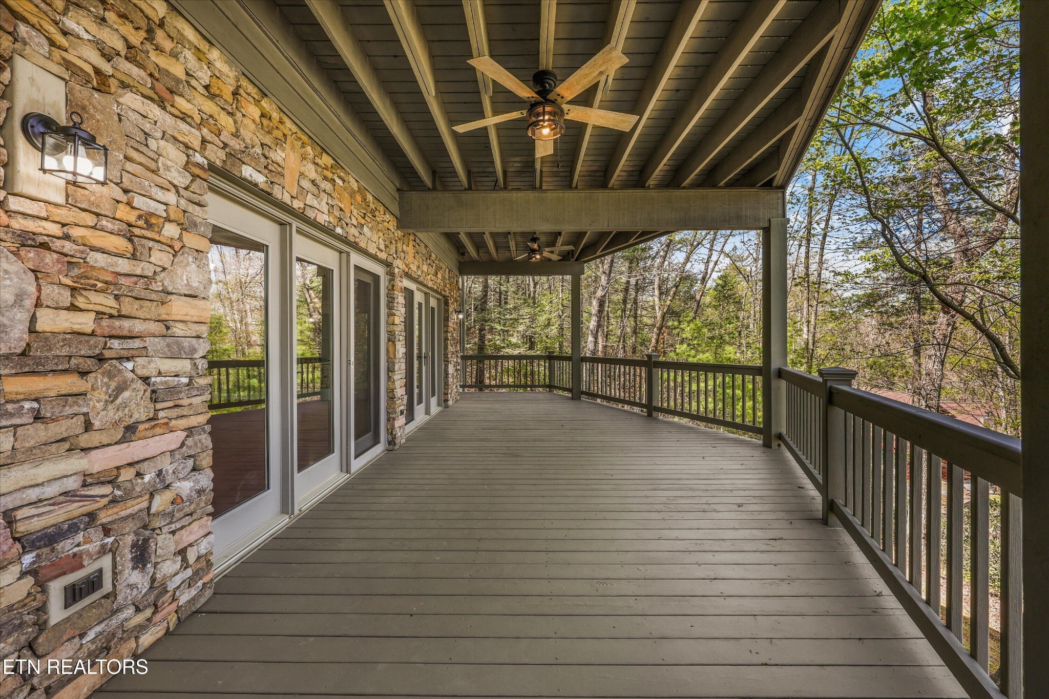 865 Stonegate Way Townsend, TN 37882 - Photo 45 of 60 a view of a porch with wooden floor and stairs
