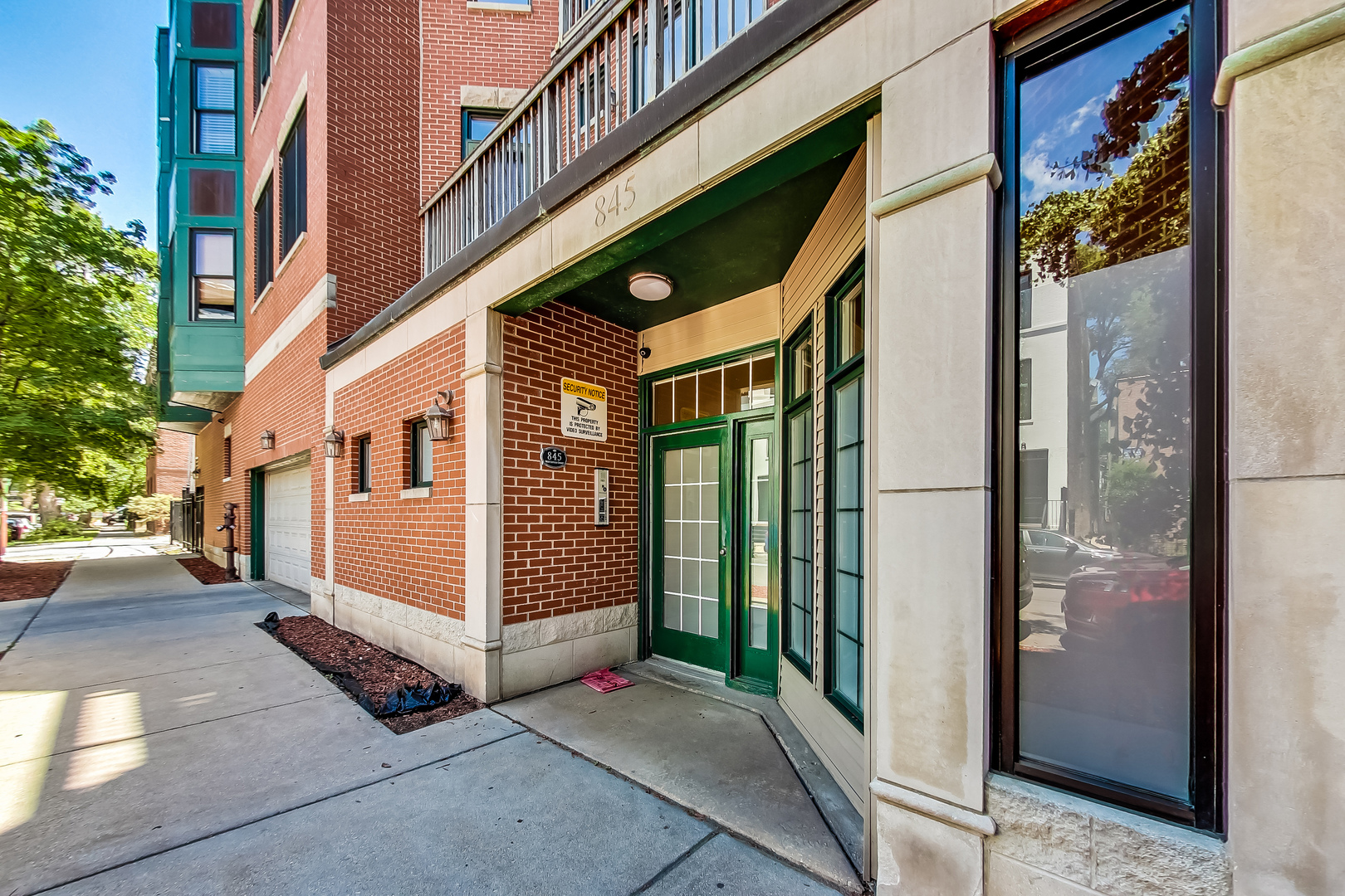 845 West Altgeld Street, Unit 2A Chicago, IL 60614 - Photo 3 of 24 a view of a large building with a large windows and a small yard