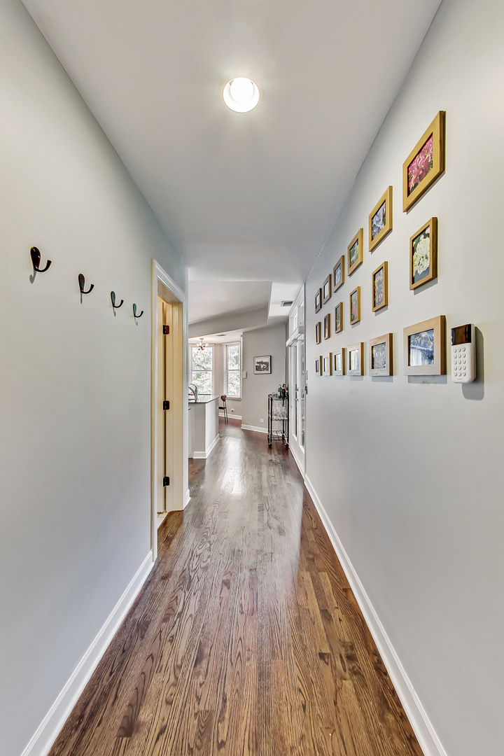 845 West Altgeld Street, Unit 2A Chicago, IL 60614 - Photo 4 of 24 a view of a hallway with wooden floor and staircase