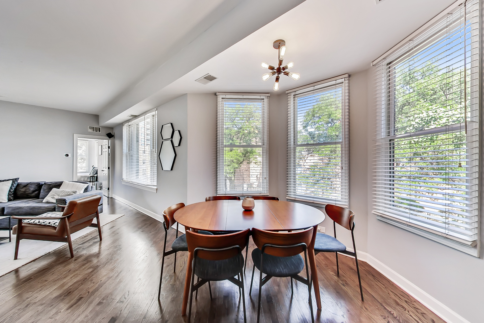 845 West Altgeld Street, Unit 2A Chicago, IL 60614 - Photo 8 of 24 a dining room with wooden floor a chandelier a glass table and chairs