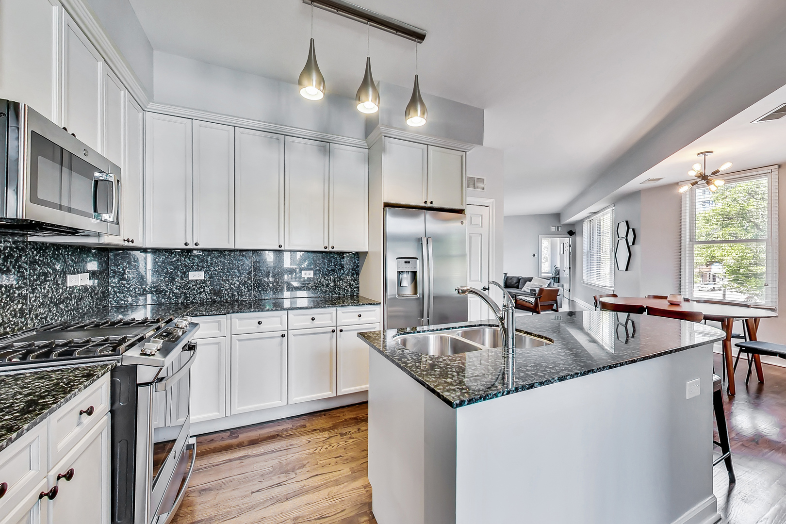 845 West Altgeld Street, Unit 2A Chicago, IL 60614 - Photo 9 of 24 a kitchen with stainless steel appliances granite countertop a sink a stove and cabinets