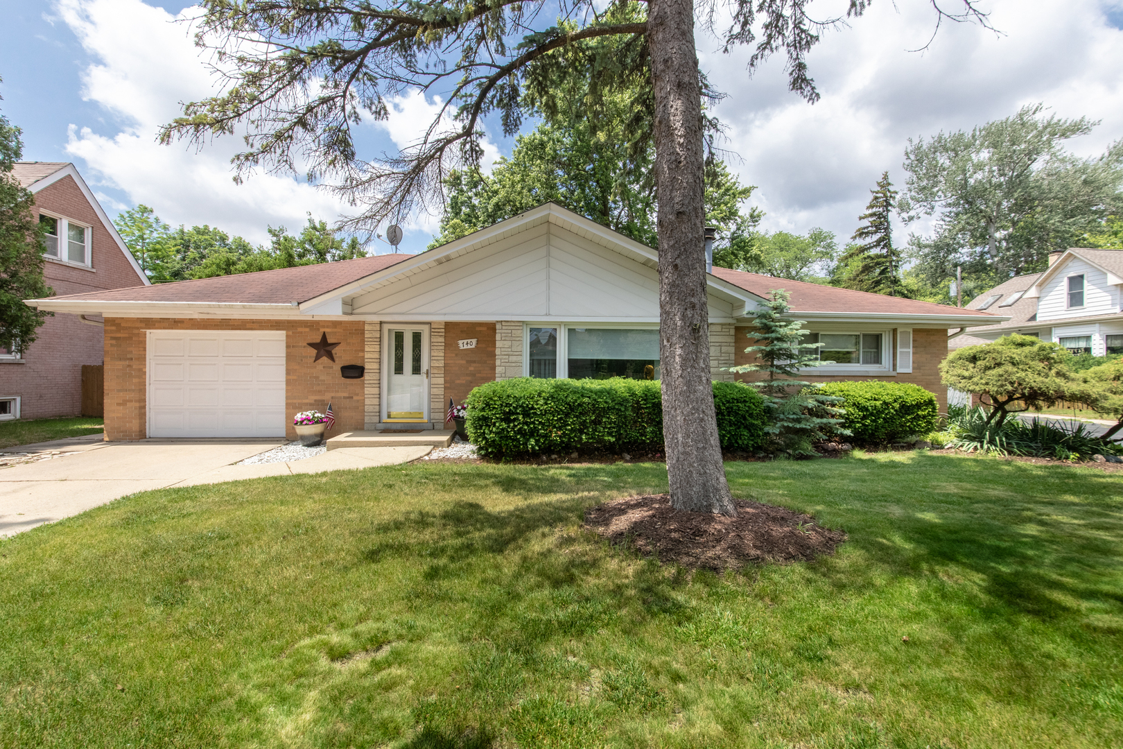 a house with green field in front of it