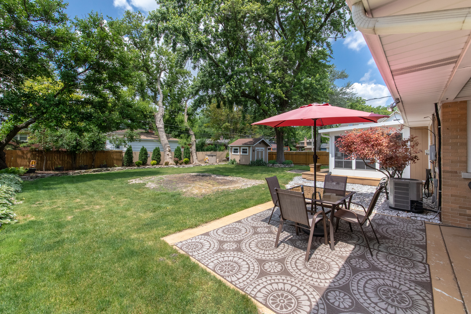 740 North Dee Road Park Ridge, IL 60068 - Photo 16 of 22 a view of a house with backyard sitting area and garden
