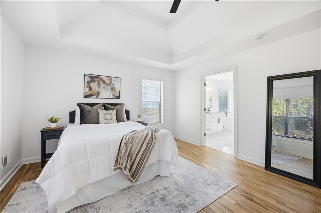 68 Winward Way Southeast Smyrna, GA 30082 - Photo 20 of 42 a spacious bedroom with a bed and a painting on the wall