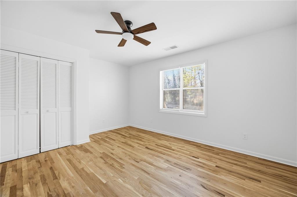 68 Winward Way Southeast Smyrna, GA 30082 - Photo 26 of 42 a view of empty room with wooden floor and fan
