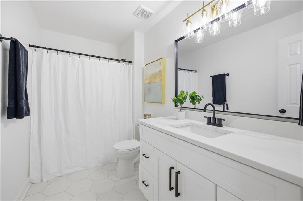 68 Winward Way Southeast Smyrna, GA 30082 - Photo 27 of 42 a bathroom with a sink a toilet and a mirror