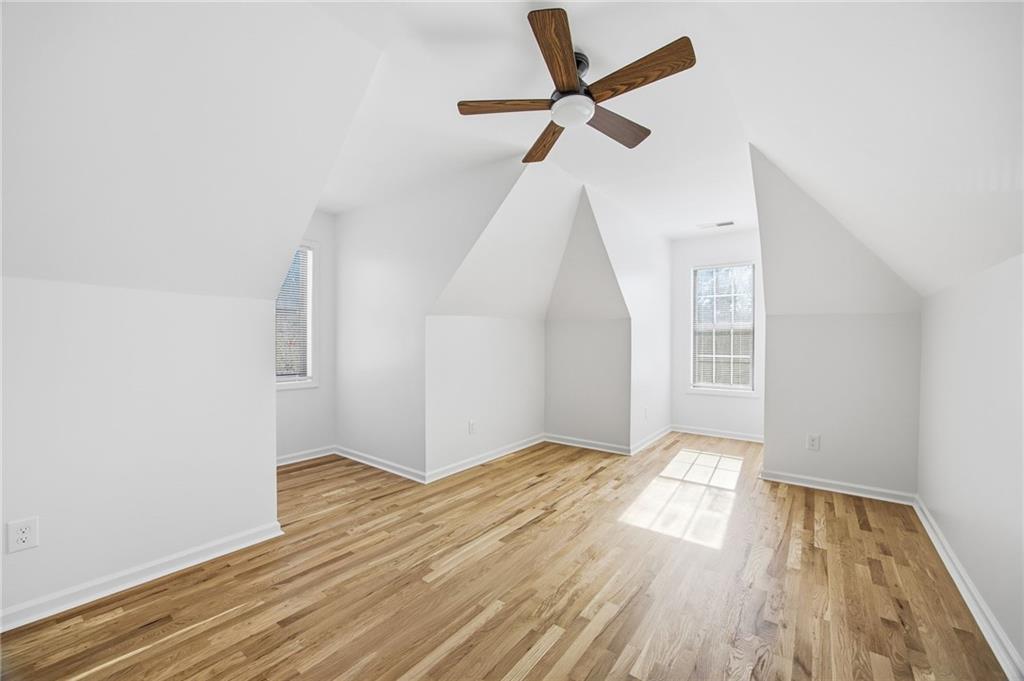 68 Winward Way Southeast Smyrna, GA 30082 - Photo 29 of 42 an empty room with wooden floor fan and windows
