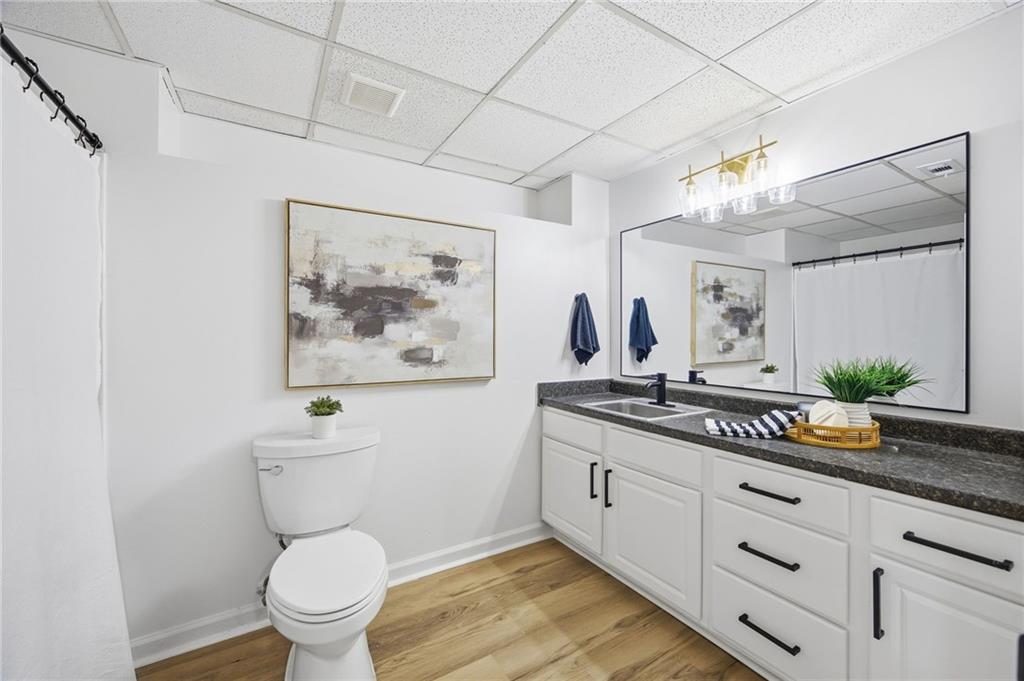 68 Winward Way Southeast Smyrna, GA 30082 - Photo 32 of 42 a spacious bathroom with a granite countertop sink a toilet and a mirror