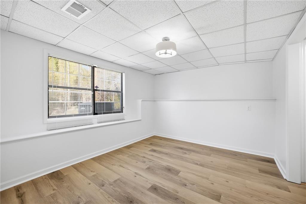 68 Winward Way Southeast Smyrna, GA 30082 - Photo 33 of 42 an empty room with wooden floor and windows