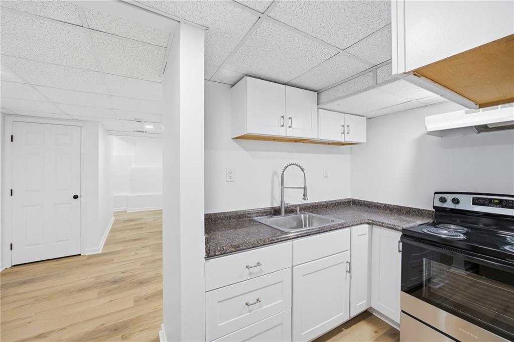 68 Winward Way Southeast Smyrna, GA 30082 - Photo 34 of 42 a kitchen with granite countertop a sink stainless steel appliances and cabinets